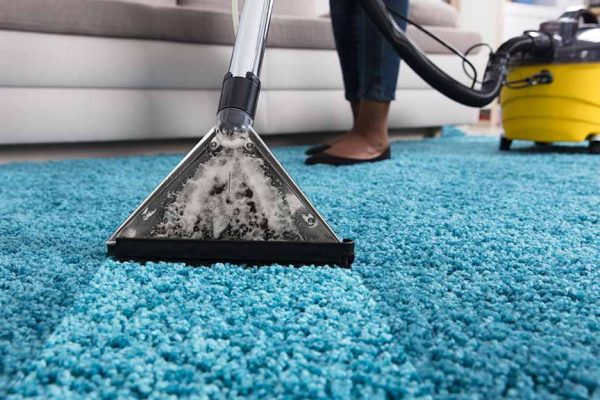 person using an at home carpet cleaner